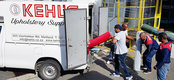Kehls Upholstery Delivery team loading the van with fabrics for our clients.